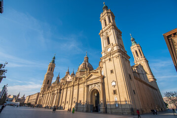 del Pilar basilica, one of the important architectural symbols of zaragoza, and the Ebro river and its reflection with sunset colors and clouds