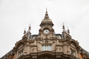 Fototapeta na wymiar Great gothic cathedral with clock in the city of Gijón de Asturias, with the sky of a cloudy day.