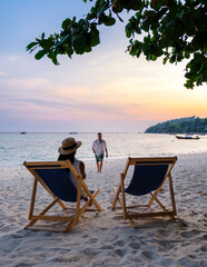 couple relaxing at a beach chair on the beach of Koh Lipe Thailand