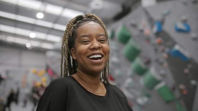 Portrait Of Smiling Young Black Female Athlete Standing In Looking To Camera 