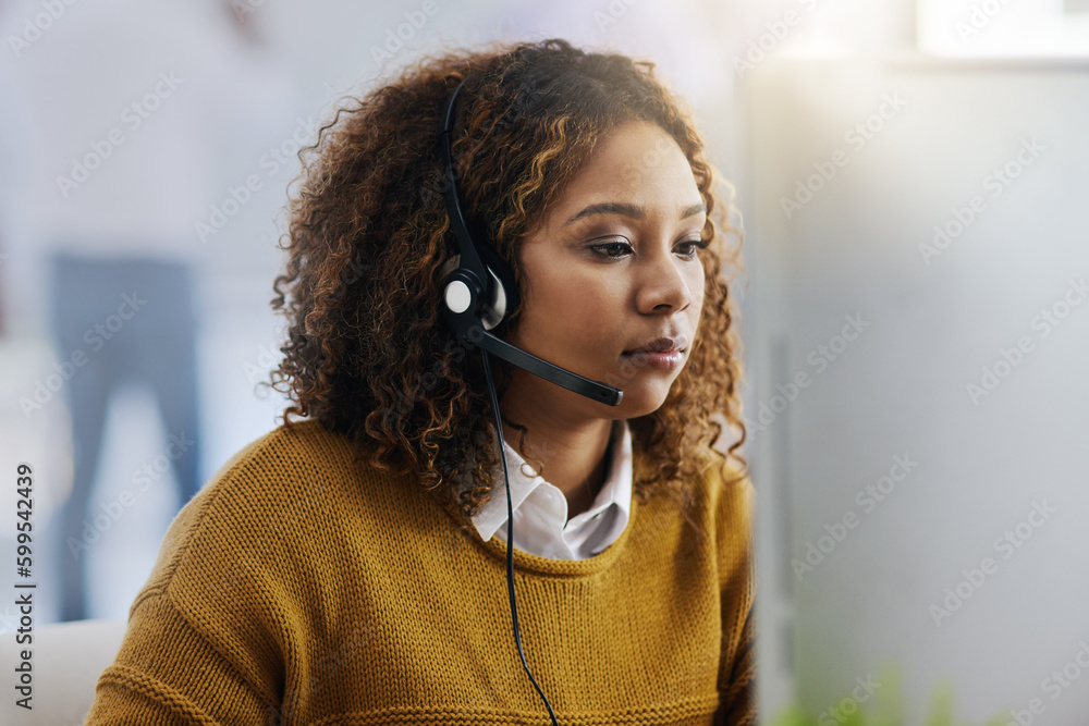 Poster working swiftly to resolve all inquiries. a female agent working in a call centre.