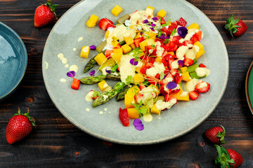 Fruit salad with asparagus, healthy meal.