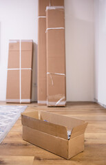 Close-up of a box with new prefabricated furniture. Packages on porch from online shopping. Repair, purchase of scrap, moving, furniture retailer, day of moving, new apartment