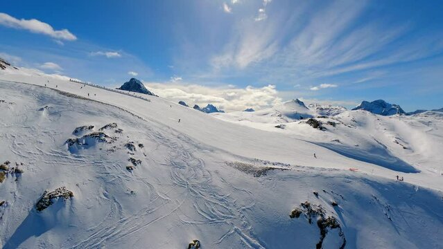 An aerial shot of a skislope in a winter mountain landscape in Les Deux Alpes, France.
