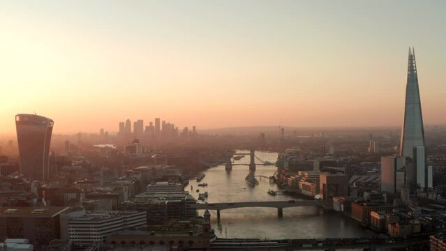 Dolly back aerial shot over central London at dawn