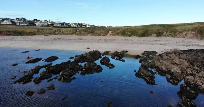 Aerial Flying Over Low Tide Rocks Beside Beach At Thurlestone. Dolly Forward Shot