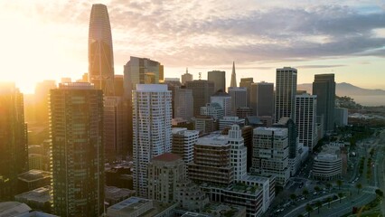 Aerial view of San Francisco skyline. Famous skyscrapers over a blue sky. Oakland Bay Bridge. California, United States. Top cinematic aerial view. 