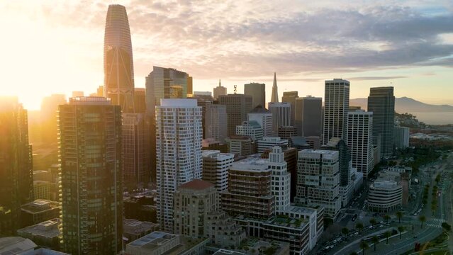 Aerial view of San Francisco skyline. Famous skyscrapers over a blue sky. Oakland Bay Bridge. California, United States. Top cinematic aerial view. 