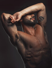 Man, body or muscle on black background in studio for fitness goals, workout or training motivation...