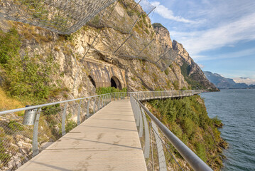 "Ciclopista del Garda" - Bicycle road and foot path over Garda lake with beautiful landscape scenery at Limone Sul Garda - travel destination in Brescia, Italy