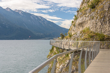 "Ciclopista del Garda" - Bicycle road and foot path over Garda lake with beautiful landscape scenery at Limone Sul Garda - travel destination in Brescia, Italy