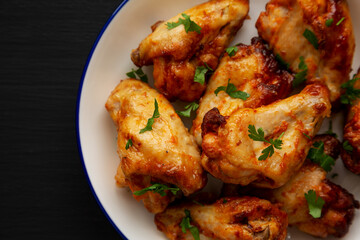 Homemade Grilled Chicken Wings with Parsley on a Plate, top view. Overhead, from above, flat lay. Copy space.