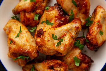 Homemade Grilled Chicken Wings with Parsley on a Plate, top view. Close-up.
