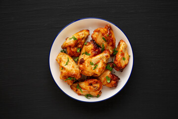 Homemade Grilled Chicken Wings with Parsley on a Plate, top view. Close-up.