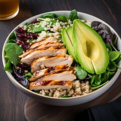 A bowl of healthy salad with grilled chicken, avocado, and quinoa