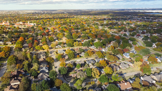 Residential neighborhood mixed of Church, School district and row of single-family house with swimming pool surrounding by colorful autumn leaves in North Texas, America