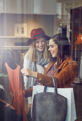 You just have the best style. two best friends out shopping in a clothing store.