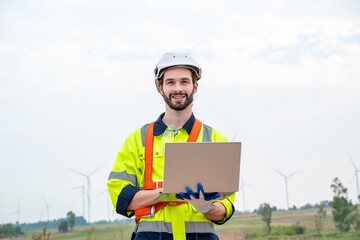 Engineer working at windmill farm,Generating electricity clean energy.