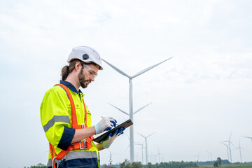 Engineer inspection wind power plants with check performance,Clean energy concept saves the world.