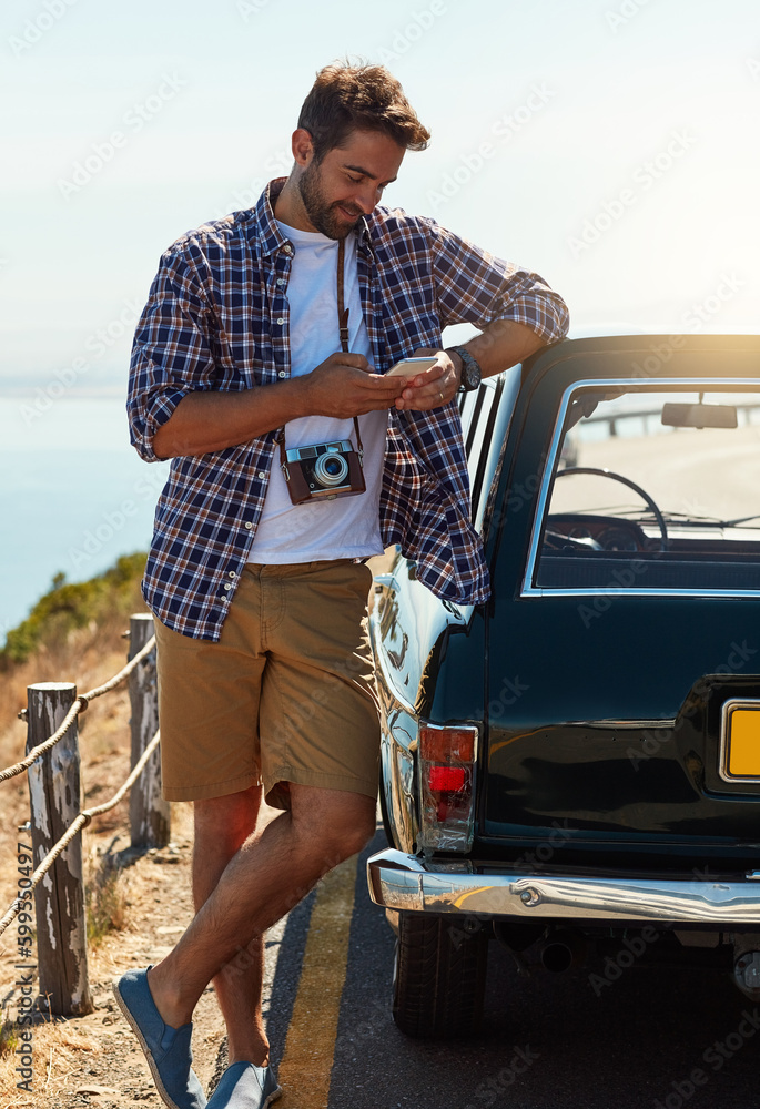 Canvas Prints Im about halfway there. Full length shot of a handsome man sending a text while enjoying a roadtrip.