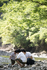 Summer vacation of siblings and dad playing in the river Images of leisure, outdoors, and camping no face