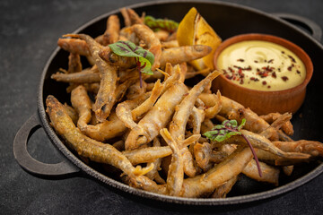 Savory anchovies seared in pan with zesty lemon and sauce