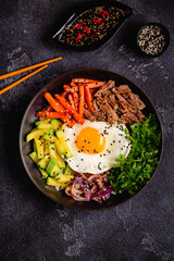 Traditional Korean dish Bibimbap: rice with vegetables beef and egg.
