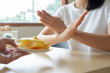 slim body Women refuse fast food or junk food, female choose salad for diet. Good healthy food. weight lose, balance, control, reduce fat, low calories, routines, exercise. rejection symbol