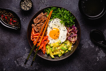 Traditional Korean dish Bibimbap: rice with vegetables beef and egg.