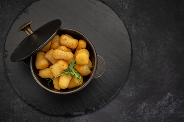 golden brown nuggets in a cast-iron dish on a stone