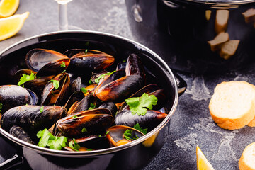 Delicious seafood mussels with sauce and parsley.