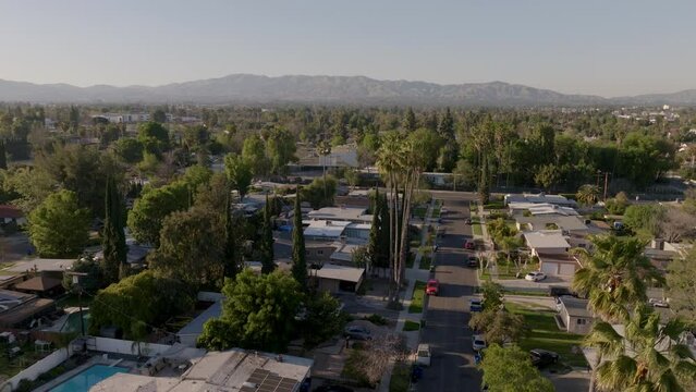 Los Angeles california suburb near downtown, view of mountains behind, aerial dolly