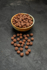 front view chocolate flakes on dark background milk meal breakfast cocoa