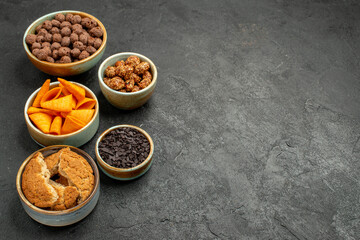 front view chocolate flakes with chips on dark-grey background color snack nut