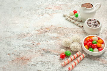 front view colorful candies with cookies on white background color rainbow biscuit tea cake