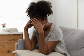 Young African woman feeling upset, sad, unhappy or disappoint crying lonely in her room. Young lady people mental health care problem lifestyle concept.