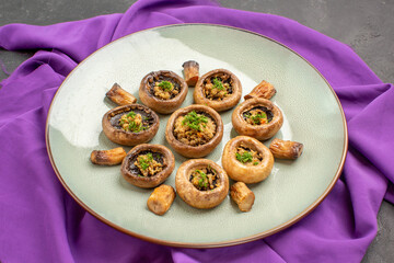 front view cooked mushrooms inside plate on purple tissue and on dark background dish meal cooking mushrooms dinner