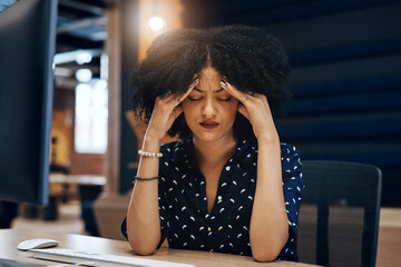 This project is just giving me a big headache. a tired young female designer looking stressed with her hands in her hair while contemplating in the office at work.
