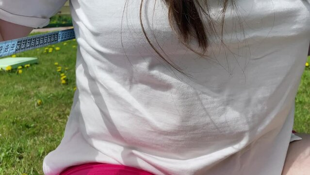 fat woman in pink sweater measures waist circumference with centimeter tape, belly stands, concept time to lose weight, wrong lifestyle, consequences of inactivity, unhealthy diet
