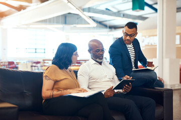 Helping the team better understand my concept. a group of designers having a discussion in an office.