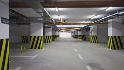 Empty shopping mall underground parking lot or garage interior with concrete stripe painted columns - Powered by Adobe