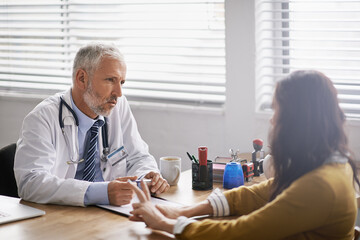 Healthcare, doctor and woman in consultation, conversation and discussion for diagnosis in an...