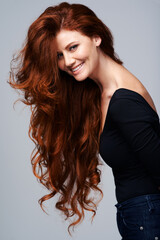 Hair care, portrait of happy red head woman and wellness in background. Beauty salon or hairstyle, cosmetic treatment and female model with natural shine in studio backdrop to promote self love