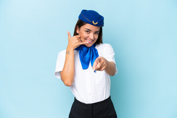 Airplane stewardess caucasian woman isolated on blue background making phone gesture and pointing front