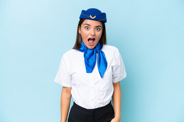 Airplane stewardess caucasian woman isolated on blue background with surprise facial expression