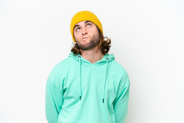 Young handsome man isolated on white chroma background and looking up