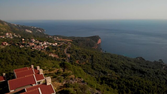 Church Of Saint Sava On Top Of The Mountain With Island Of Sveti Stefan In Montenegro In Distance. aerial  