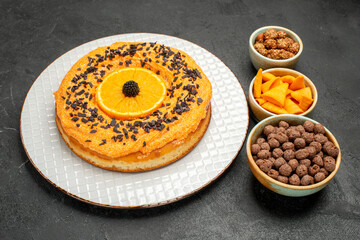 Obraz na płótnie Canvas front view delicious sweet pie with orange slices on dark-grey background pie cake dessert tea cookie