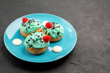 front view little creamy cakes delicious sweets for tea inside plate on a dark background tea cream cake biscuit dessert color