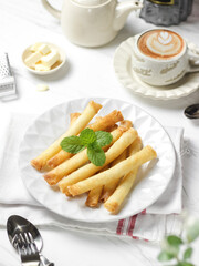 Crispy roll cheese in white plate. Crispy roll cheese is cheese that is cut and rolled with pastry skin. 
